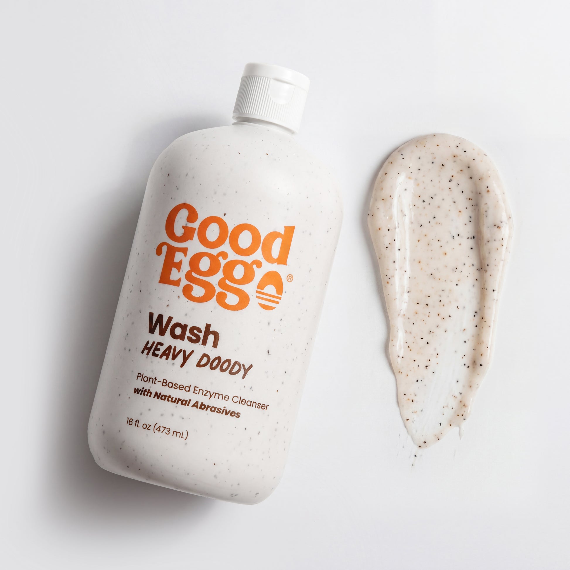 Heavy Doody Wash bottle with a smear of the wash illustrating the natural abrasives in the formula