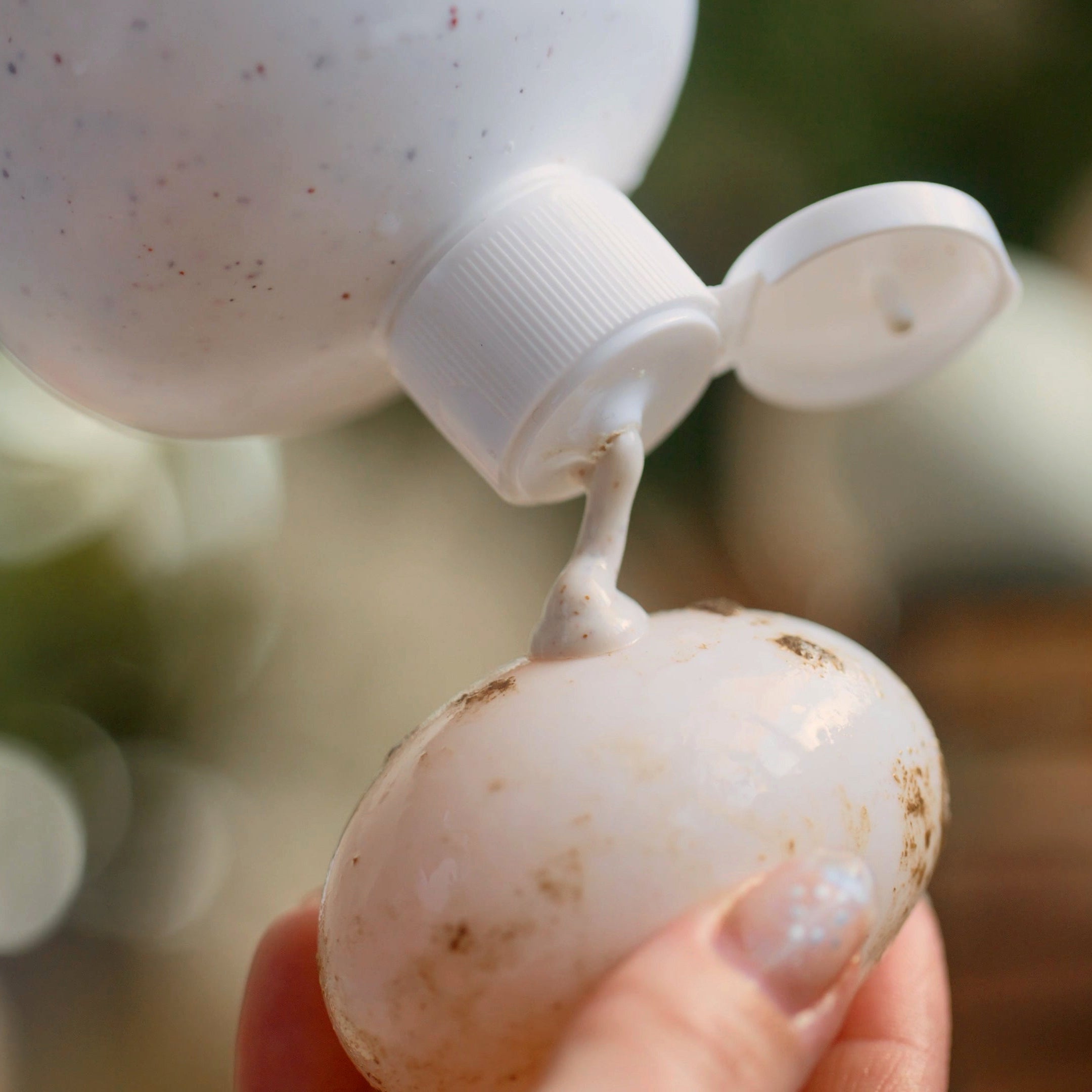 GoodEgg Wash Heavy Doody being squeezed onto a dirty egg